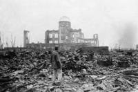 In this Sept. 8, 1945, file photo, an allied correspondent stands in a sea of rubble before the shell of a building that once was a movie theater in Hiroshima, western Japan, a month after the first atomic bomb ever used in warfare was dropped by the U.S. to hasten Japan's surrender.  (Stanley Troutman/AP File Pool Photo)