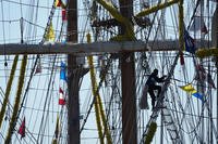 A person climbs up the rigging of the Cuauhtemoc