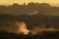 An Israeli army tank maneuvers in the Gaza Strip is seen from southern Israel