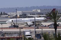 Hawaiian Airlines airplane sits on the tarmac after an evacuation