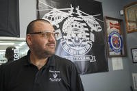 Ralph Rodriguez poses for a portrait at his pawn and gun shop in Fayetteville, N.C.