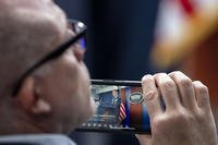 Reporter uses phone to record Pentagon press secretary Maj. Gen. Pat Ryder