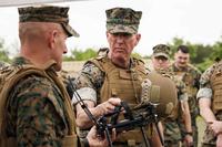 Marine Corps Gen. Eric M. Smith holds a Neros Archer drone