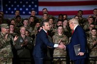U.S. Secretary of Defense Hegseth shakes hands with President Trump