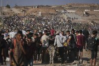 Palestinians carry humanitarian aid packages.