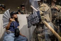 Protester standing in front of a California National Guard