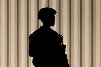 A Marine stands guard outside the Wilshire Federal Building in Los Angeles.