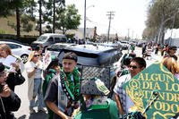 Police officers, in car, keep a watchful eye out as Gardena High School graduates mingle with family and friends in Gardena, California.
