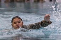 U.S. Army Pfc. Eileen Vasquez, a soldier with 24th Military Intelligence Battalion, 66th MI Brigade, swims 100 meters in uniform for the German Armed Forces Proficiency Badge at a swimming pool in Wiesbaden, Hessen, D.E.