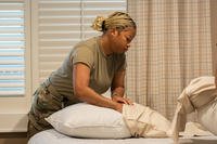 U.S. Air Force Airman 1st Class Dezi Woodall, Air Force Mortuary Affairs Operations departures specialist, replaces a pillow cover in one of the bedrooms of the Fisher House at Dover Air Force Base, Delaware.