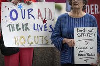 Federal workers and supporters rally outside of the State Department