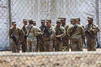 California National Guard troops stand outside a large tent city