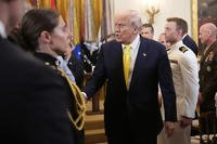 Trump greets attendees as he departs an event to mark National Purple Heart Day