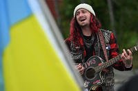 James Garrett Hermansen sang original protest songs as people showed their support for Ukraine outside the Government Hill gate prior to the summit with President Donald Trump and Russia President Vladimir Putin on Joint Base Elmendorf-Richardson in Alaska.