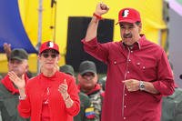 Venezuelan President Nicolas Maduro raises his fist