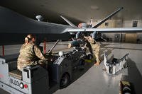 U.S. Air Force U.S. Air Force Tech. Sgt. Rachel Harmon and Master Sgt. Tom Anderson, weapons loaders assigned to the 174th Attack Wing, checks an inert GBU 12 laser guided missile on an MQ-9 Reaper at Springfield-Beckley Air National Guard Base in Springfield, Ohio.