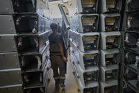 A worker carries part of a combat drone at Fire Point's secret factory in Ukraine