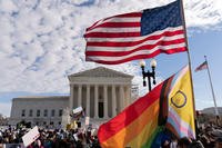 Transgender rights supporters rally outside of the Supreme Court