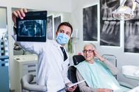 A patient and dentist look at X-rays.