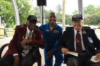 NASA astronaut Victor Glover Jr., center, is flanked by former Tuskegee Airmen Lt. Col. James Harvey, left, and Lt. Col. George Hardy