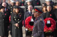King Charles III salutes as he attends the Remembrance Sunday Service.
