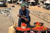 A man sells tomatoes and peppers at the market in Kaduna, Nigeria, Thursday, Nov. 6, 2025. (AP Photo/Sunday Alamba)