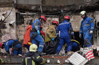Rescuers carry the body of a victim.