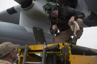 U.S. Marine Corps Sgt. Paul A. Millis, crew chief assigned to Marine Aerial Refueler Transport Squadron (VMGR) 252, raises a lift in preparation for a Flight In Support of a Deployed Unit (FISDU) at the Shannon Airport, Ireland, March 12, 2015.  (U.S. Marine Corps photo by Lance Cpl. Koby I. Saunders/Released)