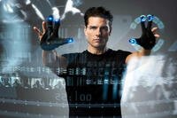 A man stands inside a glowing circular tunnel, facing forward in a sterile, futuristic environment. Photo credit: 20th Century Fox / Everett Collection