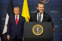 Defense Secretary Pete Hegseth, right, speaks President Donald Trump listens during the Shield of the Americas Summit, Saturday, March 7, 2026, at Trump National Doral Miami in Doral, Fla. (AP Photo/Mark Schiefelbein)