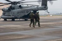 U.S. Marines with Marine Heavy Helicopter Squadron 466, Marine Aircraft Group 36, 1st Marine Aircraft Wing walk toward a CH-53E Super Stallion helicopter on Suwon Air Base, Gyeonggi-do, South Korea, April 6, 2026, after Korean Marine Exchange Program 26.1. (U.S. Marine Corps photo by Cpl. Jeremiah Barksdale)