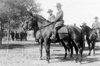 Gen. Pershing on a horse in black and white.