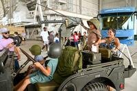Kids in a jeep at a display.
