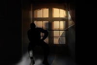 Veteran contemplating behind window.