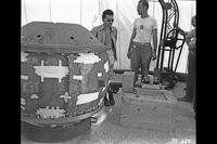 Louis Slotin (left) and Herbert Lehr with the Gadget bomb, July 13, 1945. (Los Alamos National Laboratory photo)