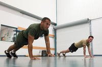 A Marine completes push-ups during a physical training session.