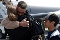 airman hugs wife