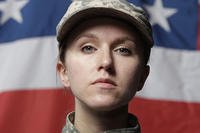 female soldier with American flag in the background