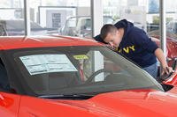 man looking at car in showroom