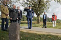 Col. Harry Benham, the U.S. Air Forces in Europe-Air Forces Africa operations and plans chief, salutes during the revealing of a memorial stone for 2nd Lt. Priesley Cooper Jr. in Dietingen, Germany. (U.S. Air Force/Staff Sgt. Armando A. Schwier-Morales)