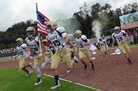 Midshipmen with the United States Naval Academy's Sprint football team rush out to the field at the Mexican Sedena Heroico Colegio Militar for an exhibition game with their Mexican counterparts in Mexico City, Mexico. (DoD photo by Lisa Ferdinando)