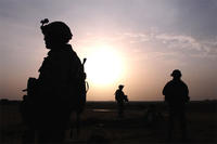 U.S. Army soldiers are silhouetted by the sun as they search a small village for anything suspicious during Operation Syme in Tikrit, Iraq, Oct. 28, 2008. U.S. Army photo by Sgt. 1st Class Kevin Doheny