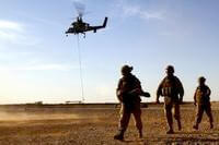 Marines with Combat Logistics Battalion 5 return from familiarizing themselves with the downward thrust of a Kaman K1200, or &quot;K-MAX,&quot; unmanned helicopter during initial testing in Helmand province, Afghanistan, May 22.