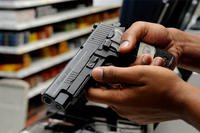 A patron at the Barksdale Base Exchange shops for a new pistol. (USAF photo/TSgt Laura K. Smith)