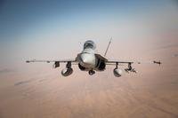 An F/A 18C Hornet approaches the rear of a KC-130J Hercules during a fixed-wing air-to-air refueling mission April 16, 2015.(Official Marine Corps Photo by Cpl. Charles Santamaria/ Released)