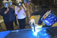 A welder authenticates the keel by welding the initials of the ship's sponsor onto the keel plate of the future USS Billings (LCS 15), in a ceremony held at Fincantieri Marinette Marine in Marinette, Wisconsin. (Photo by Lockheed Martin)
