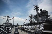 The Nimitz-class aircraft carrier USS Carl Vinson (CVN 70), right is moored pierside in Singapore, April 4, 2017. (U.S. Navy/Mass Communication Specialist 2nd Class Z.A. Landers)