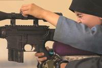 A boy claiming to be 10 years old and the son of American parents features in a new ISIS propaganda video. (Photo: Middle East Media Research Institute)