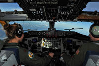 Maj. Gena Fedoruk and Maj. Stephanie Blech fly a KC-135 Stratotanker during a refueling mission March 13, 2014.