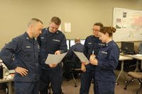 Members of the Coast Guard Sector Anchorage, Alaska, Incident Management Team for the Alaska Shield 2014 exercise examine data during a morning meeting March 31, 2014.